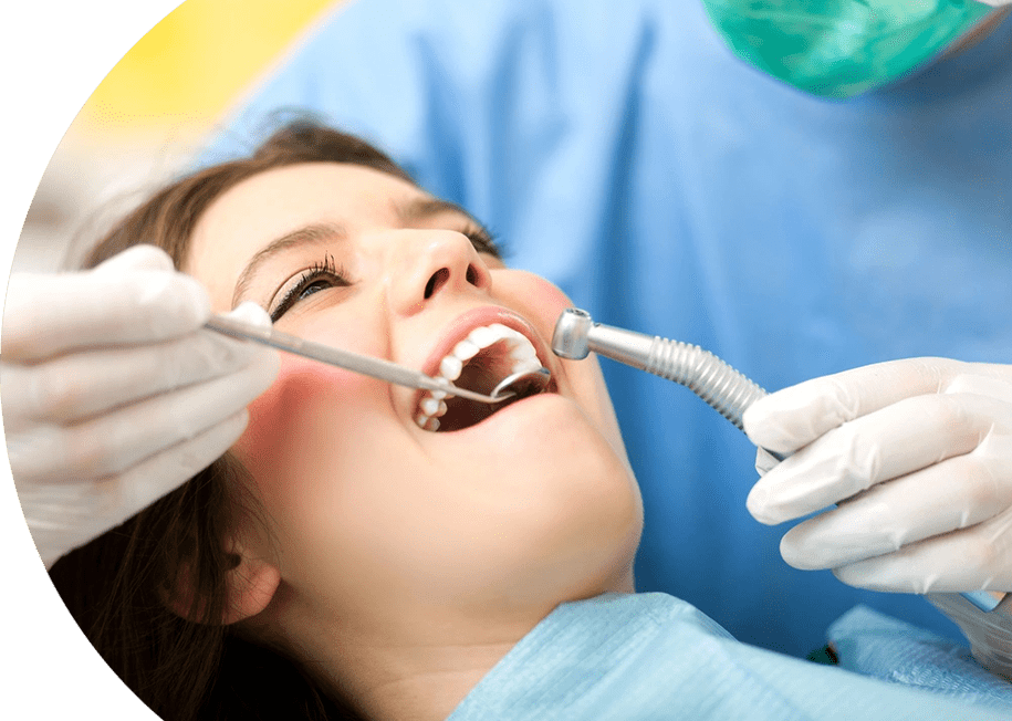 A woman is getting her teeth cleaned by dentist.