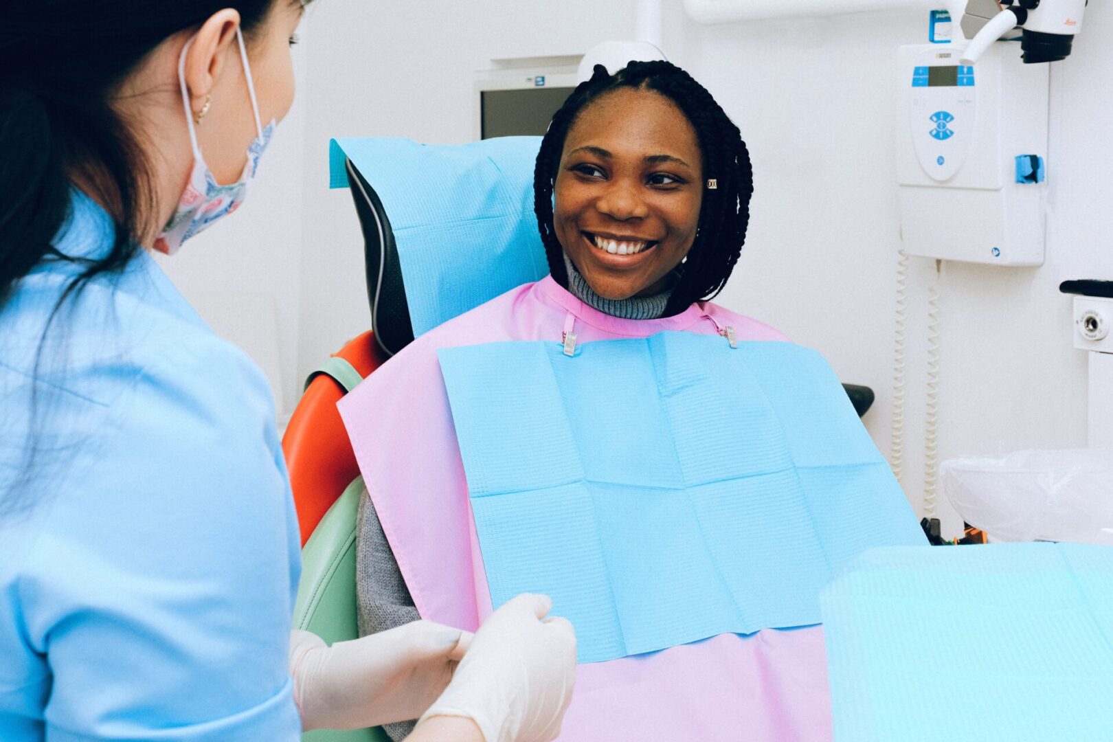 A woman sitting in the dentist chair smiling.