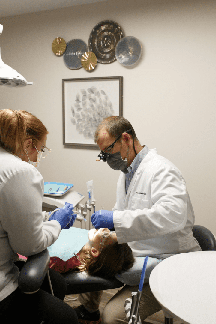 A dentist and his assistant performing an exam on a child.