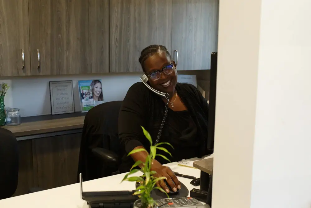 A person sitting at a desk with a laptop